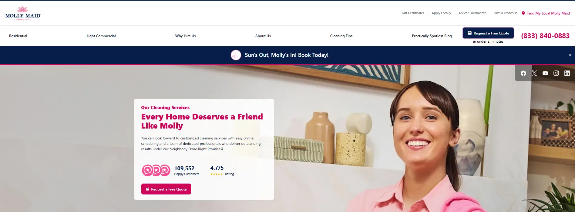 Smiling person in pink shirt indoors with decor items in the background