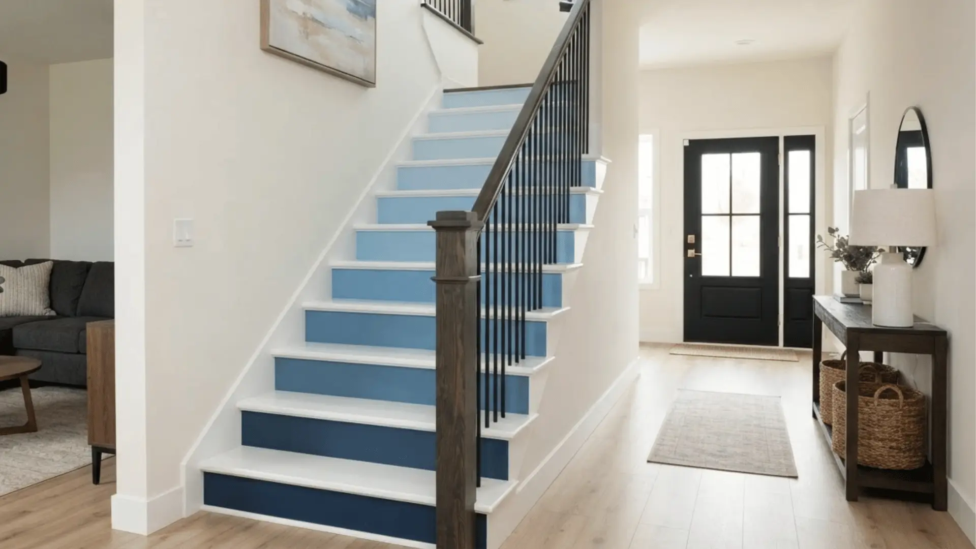 white stairs with ombre blue risers fading from navy to pale blue in a coastal entryway