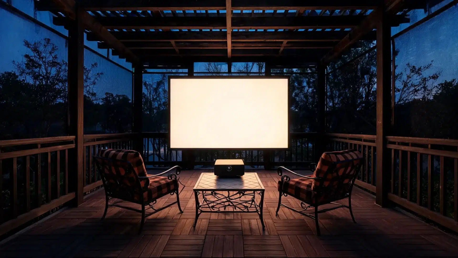 blank white projection screen at far wall facing a projector on a coffee table flanked by two armchairs