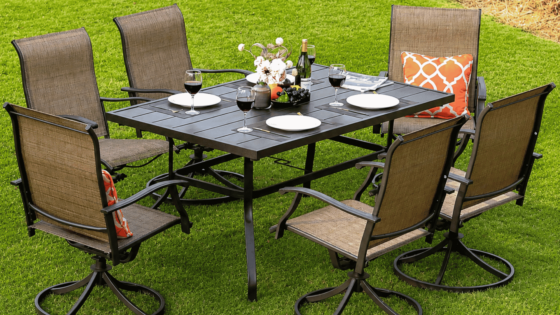 outdoor patio dining set with six swivel chairs and table setup on green lawn in sunny backyard