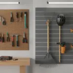 Organized workshop wall with tools hanging on pegboard and slatwall next to wooden workbench