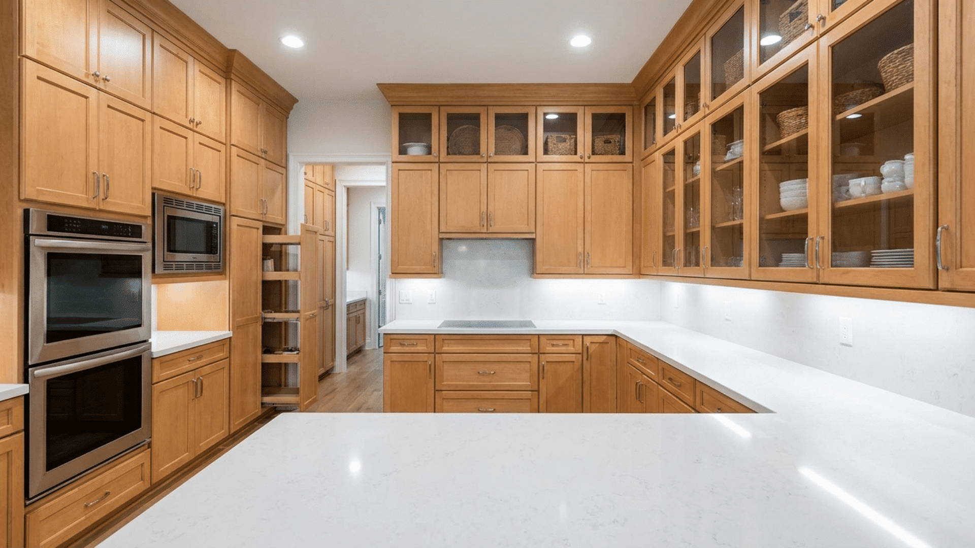 U-shaped kitchen with floor-to-ceiling cabinets for vertical storage.