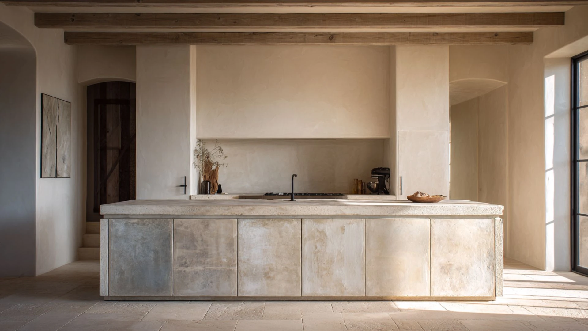 wabi-sabi kitchen island with aged lime-washed plaster cabinet panels and rough-edged concrete countertop surface