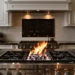 Gas flame on stainless steel stove in luxurious kitchen with marble countertop