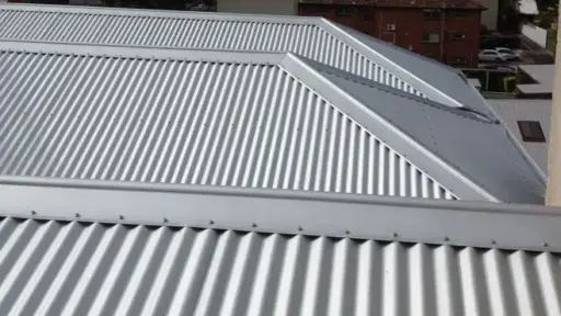 Corrugated metal roofing on residential building under overcast sky