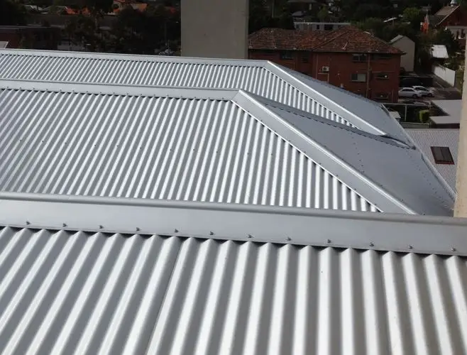 Corrugated metal roofing on residential building under overcast sky