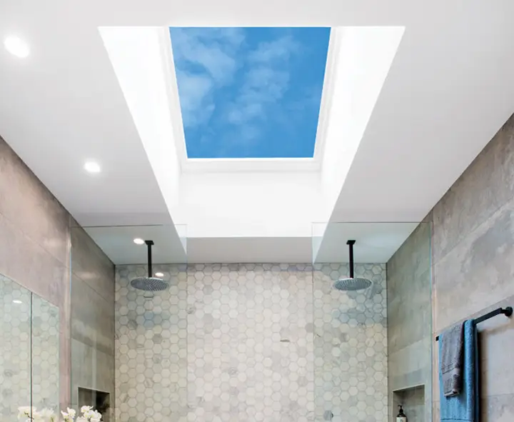 Modern bathroom with skylight, hexagonal tiles, dual rain showerheads, and gray walls