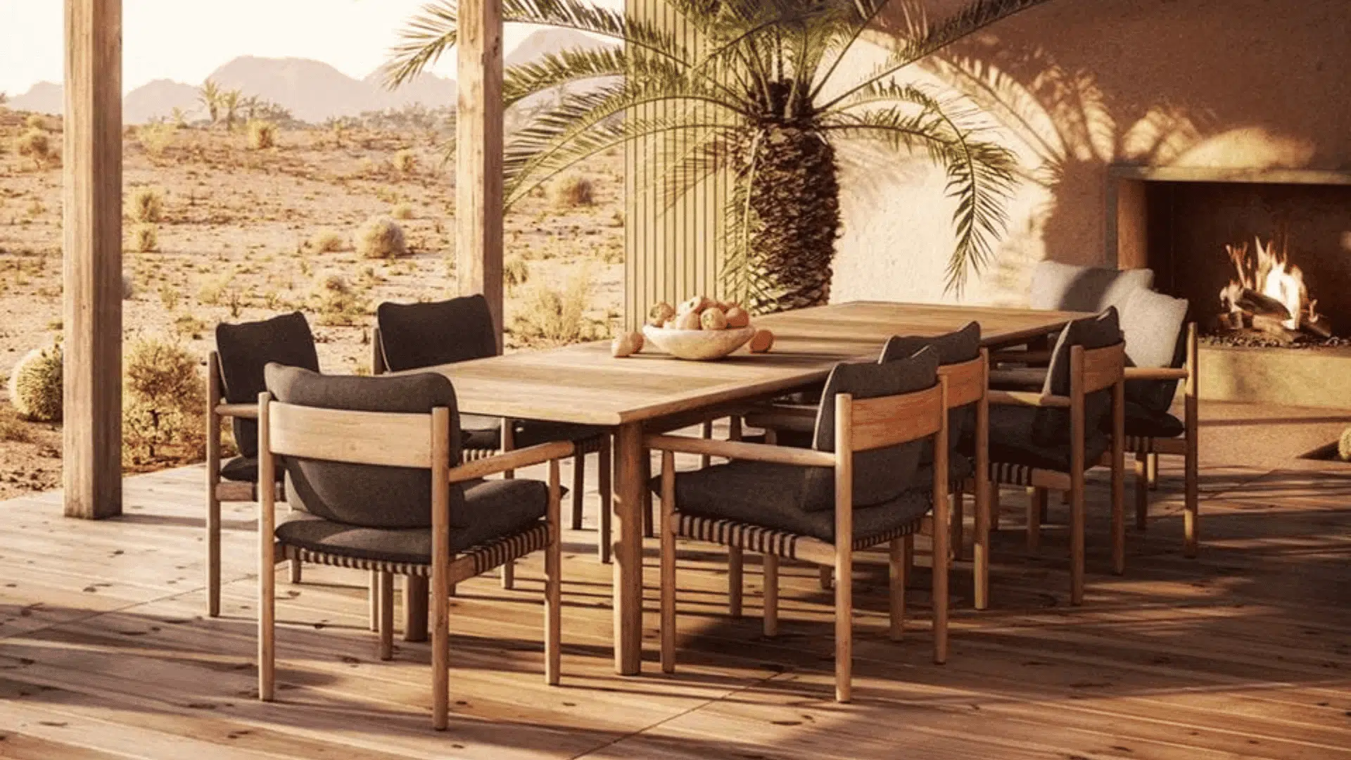 wooden outdoor dining set with cushioned chairs beside fireplace in warm desert style patio setting