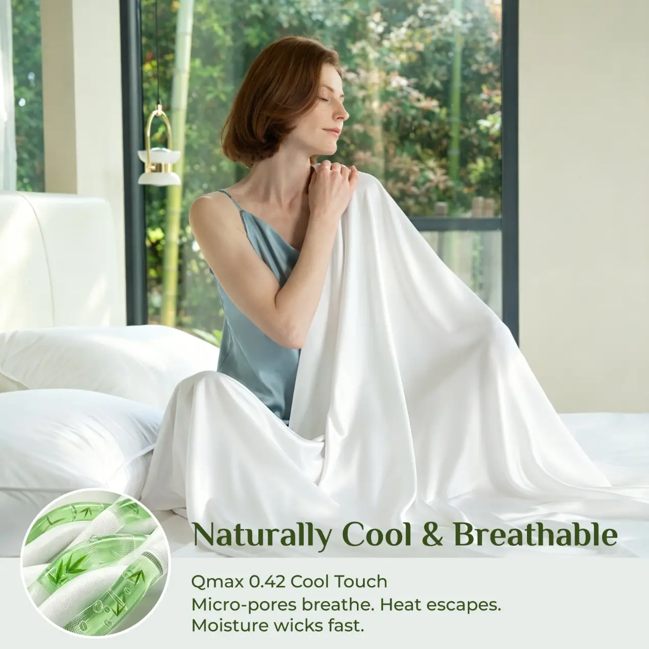 Woman in silk nightgown holding white sheets in bright bedroom with garden view
