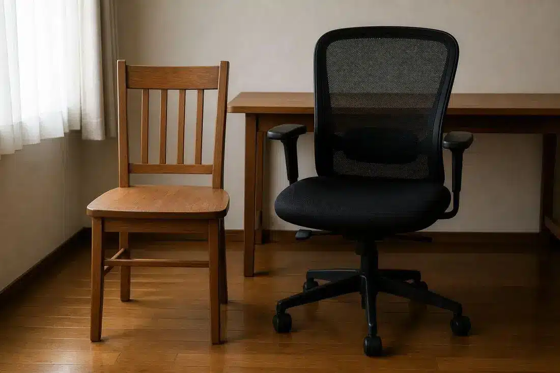 Wooden chair and black office chair side by side on wooden floor in a room