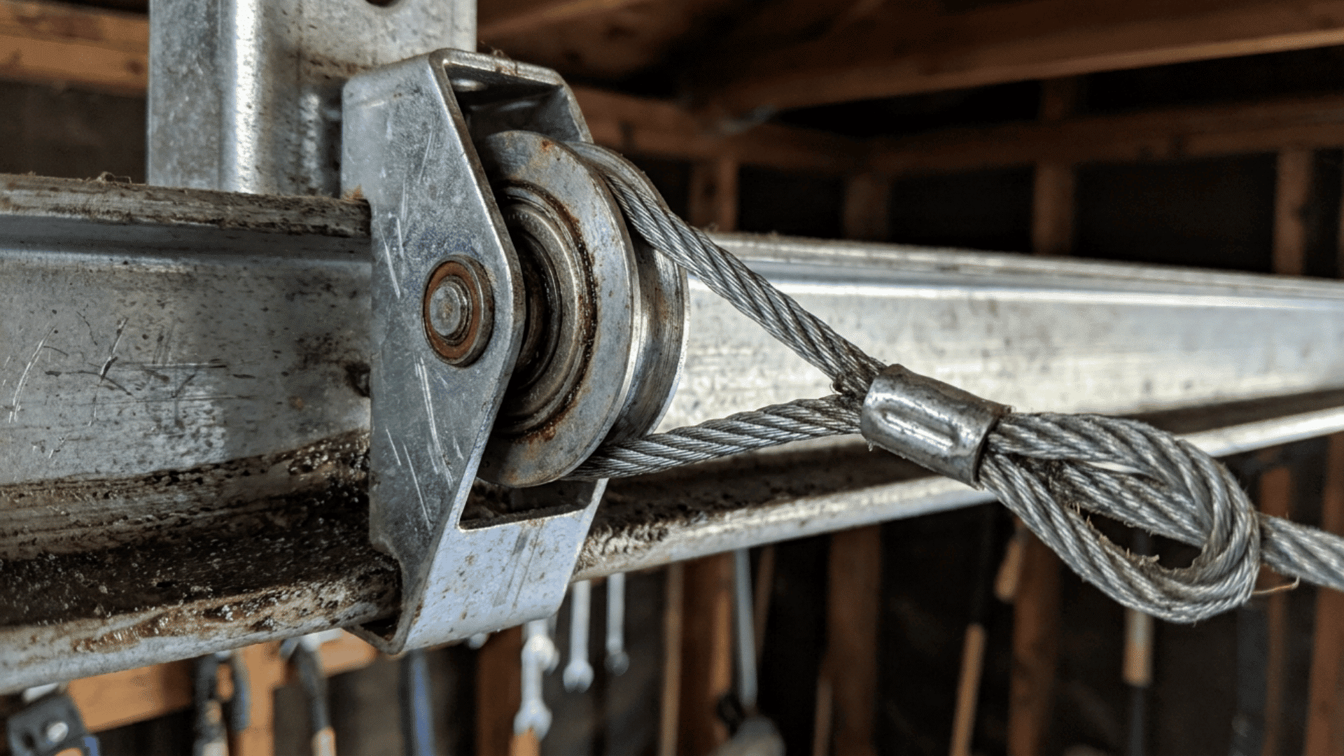 extension spring garage door lift cable running through track pulley