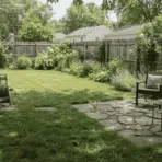 finished backyard with trimmed lawn stone patio and outdoor seating area