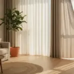 Woman opening curtains in sunlit living room with beige sofa and potted plant