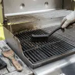 dirty and clean grill grates shown side by side during cleaning with safe tools outdoors