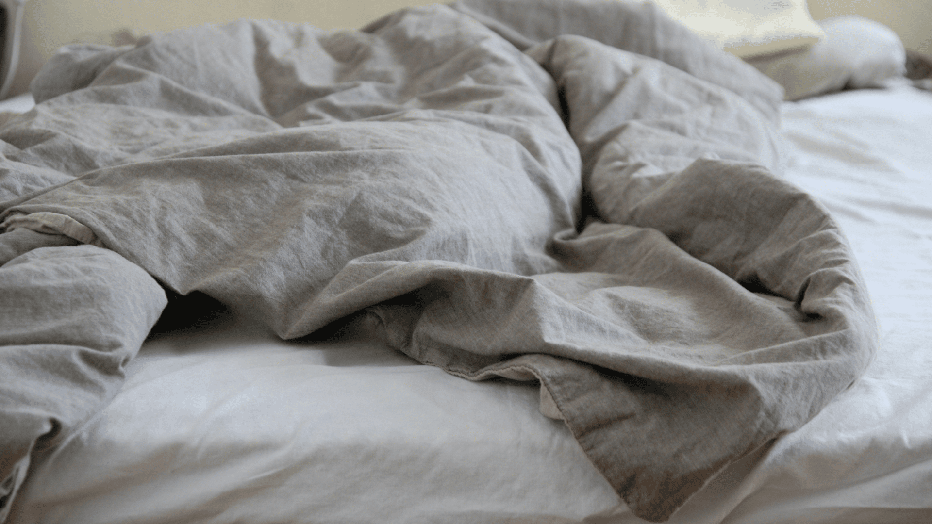 light breathable cotton comforter spread across a bed to help reduce trapped body heat while sleeping