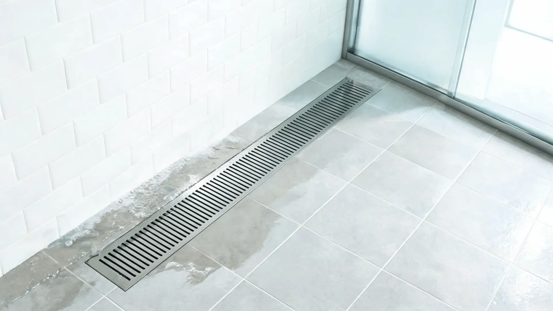 long linear shower drain channel set along a modern tiled walk in shower floor