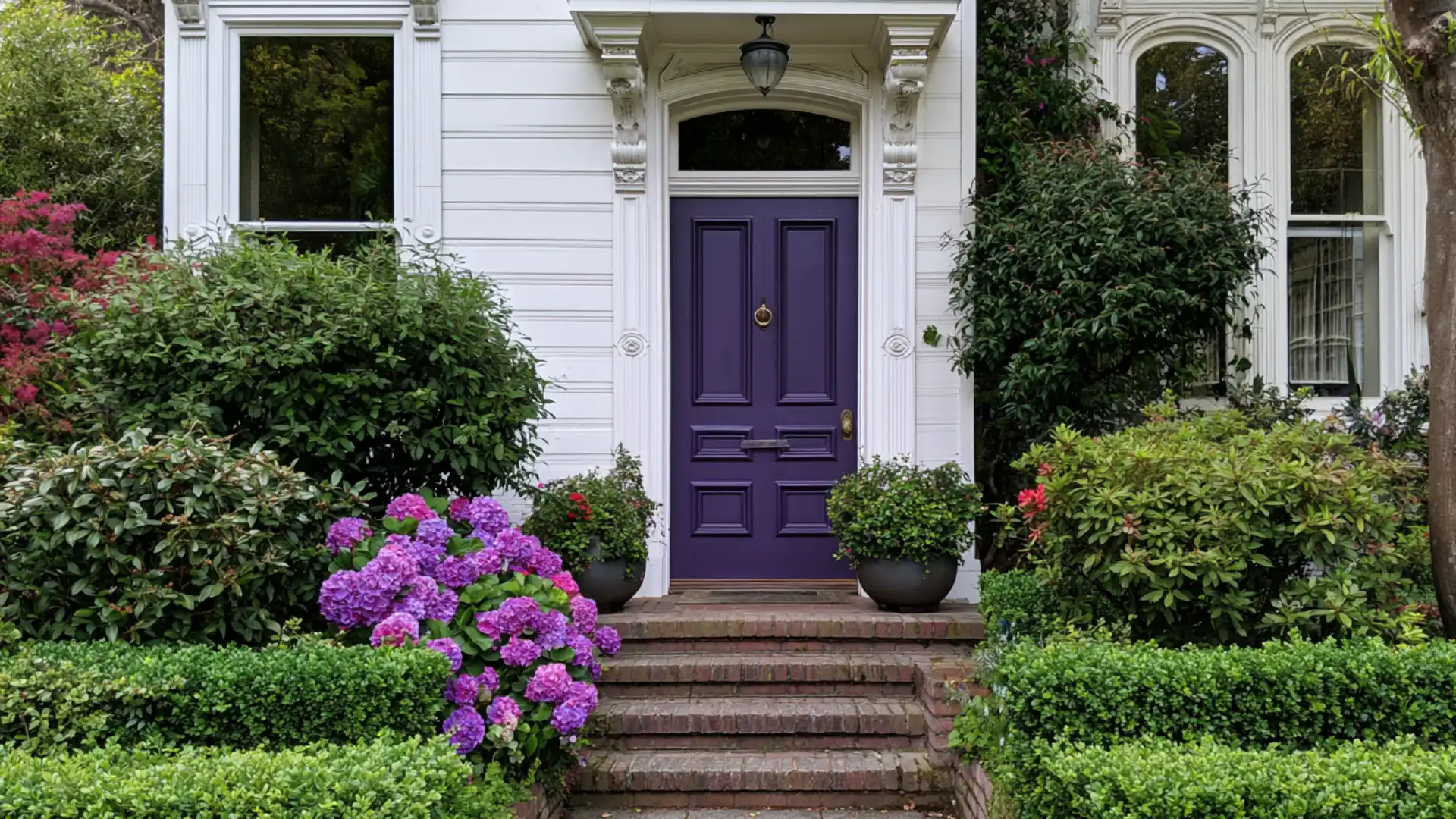 deep purple front door with ornate trim details on victorian style home exterior