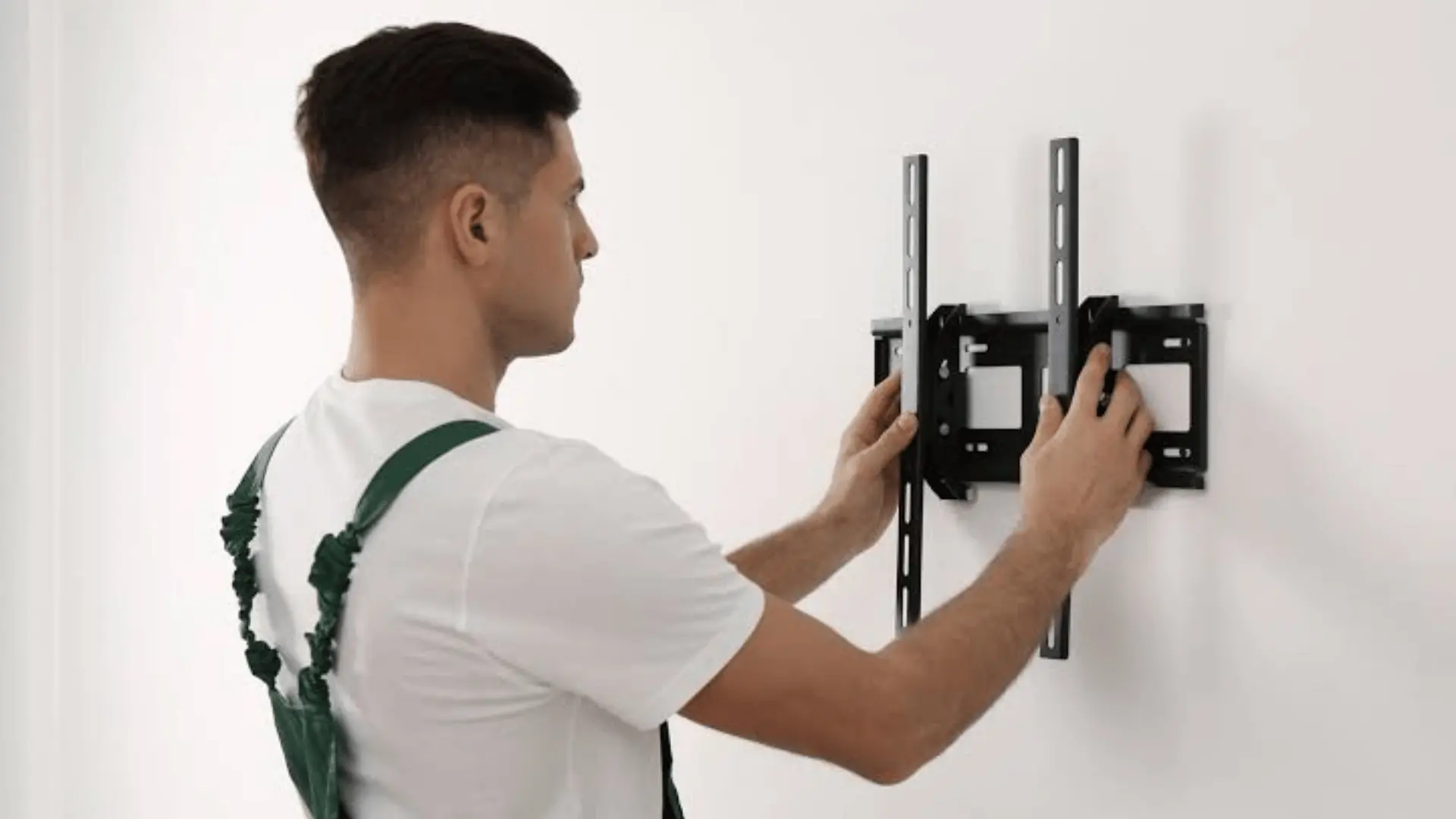 installer aligning a television wall plate against the wall