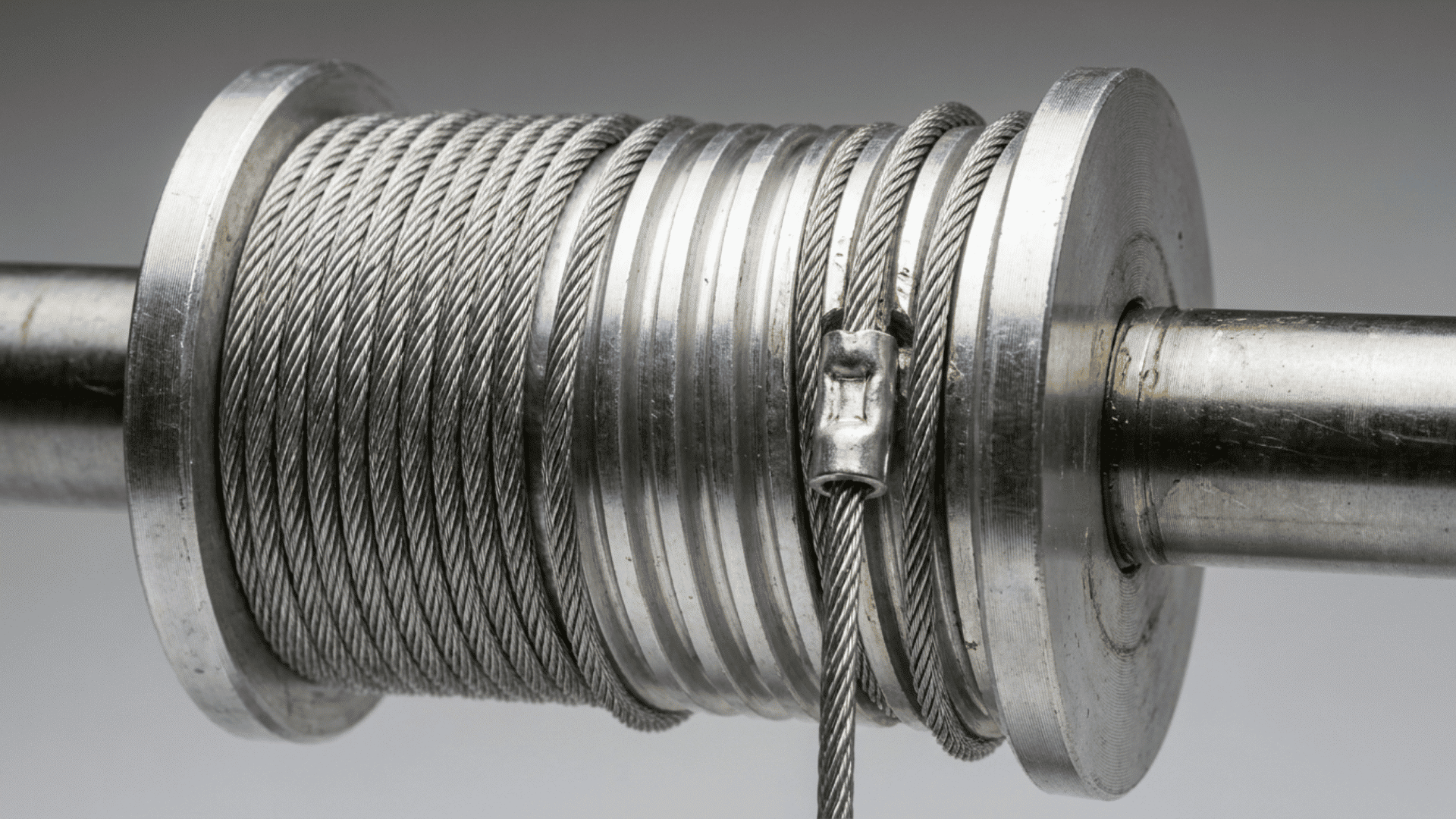 close up of galvanized torsion spring garage door lift cable on drum