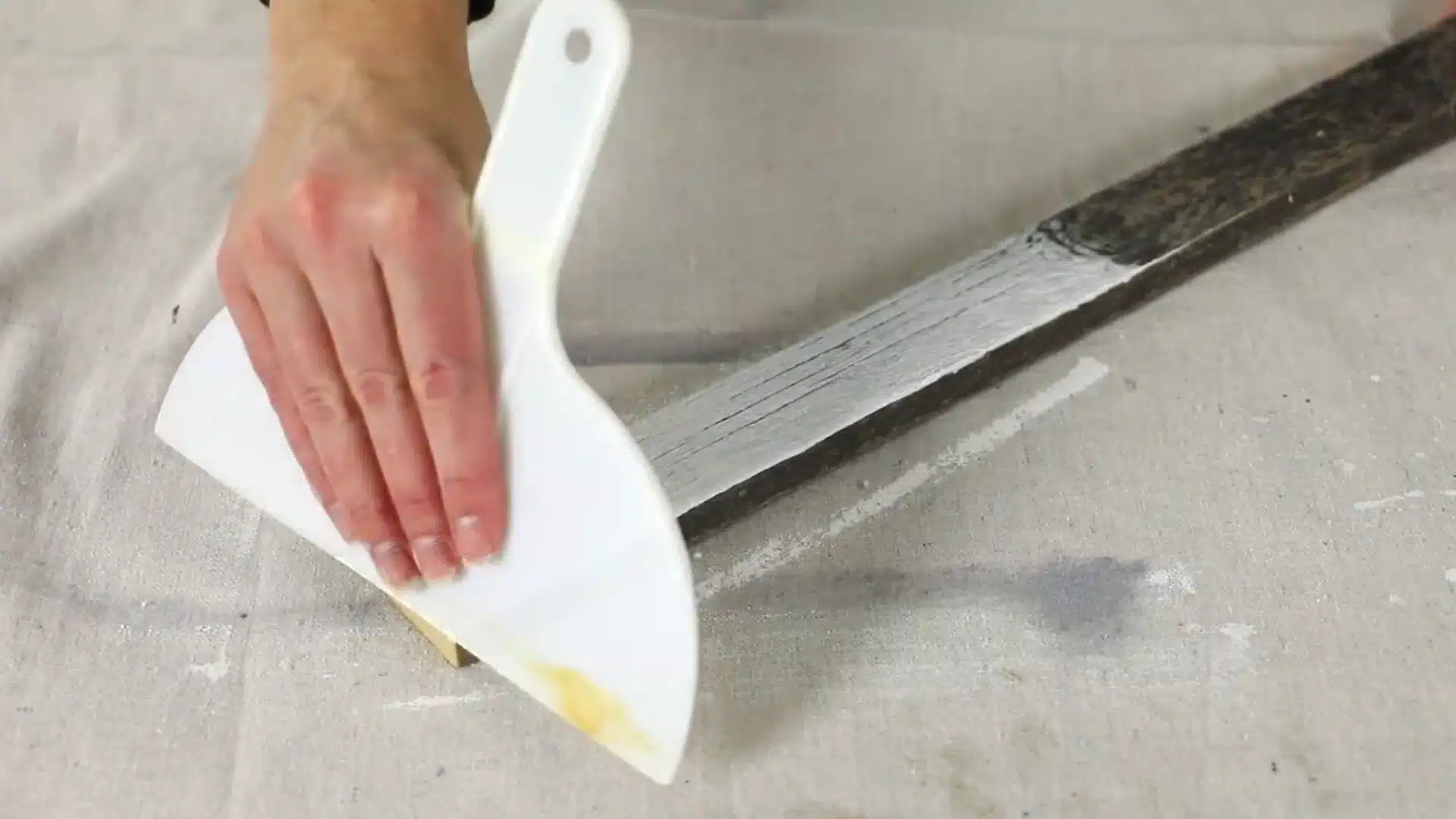 wiping excess white wash off wood with cloth scraper