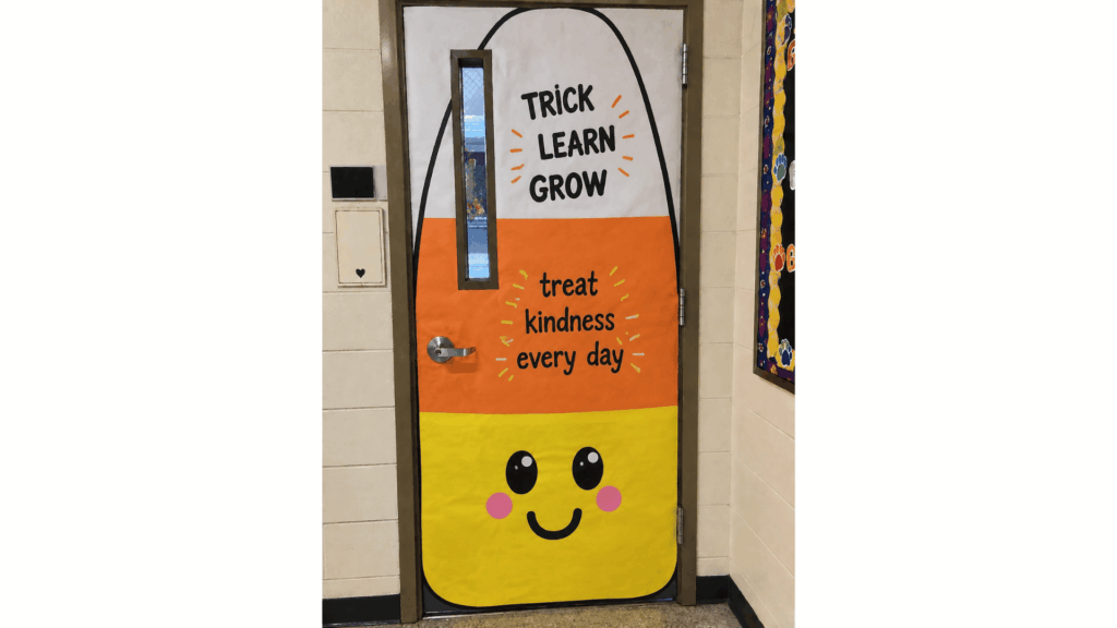 classroom door shaped like candy corn with the message "Trick Learn Grow"