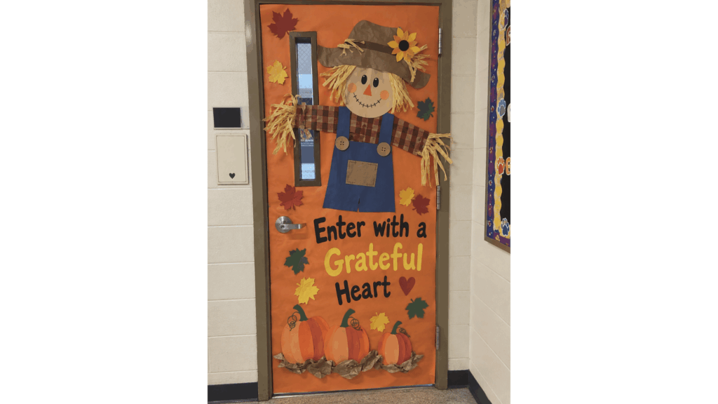 fall classroom door scarecrow with the message "Enter with a Grateful Heart"