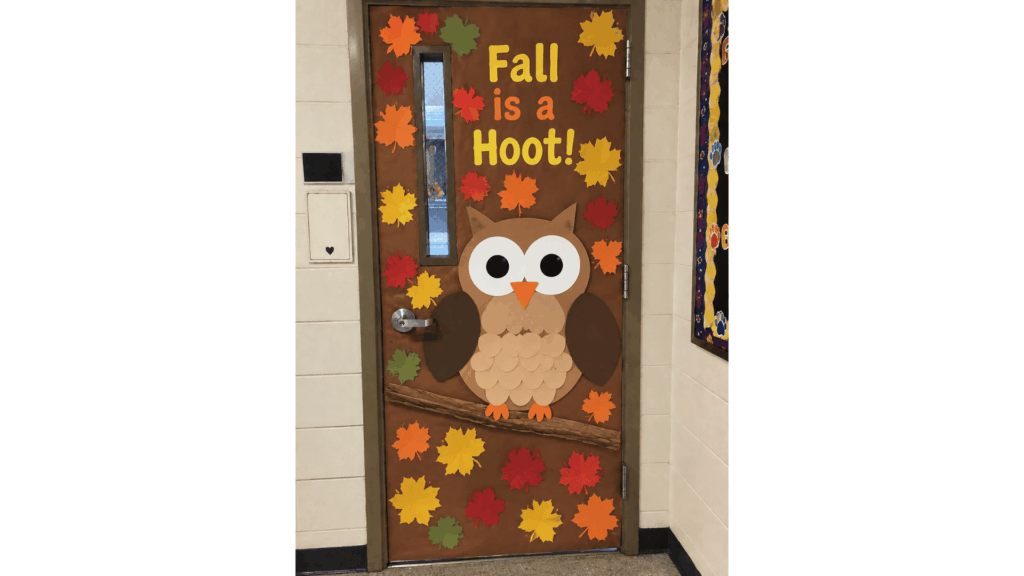 fall classroom door with a large paper owl and "Fall is a Hoot" lettering