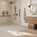 Modern bathroom with walk-in shower, wood vanity, and woven baskets under natural light