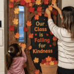 teacher and student decorating a fall classroom door with colorful leaves and an autumn tree.