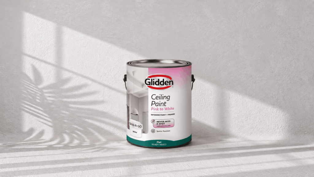 behr ultra stain blocking ceiling paint sitting on a wooden table in a softly lit room