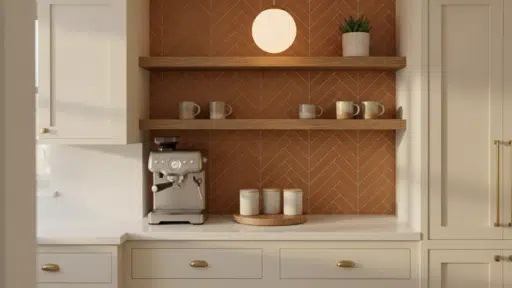 Coffee machine on kitchen counter with terracotta herringbone backsplash and wooden shelves
