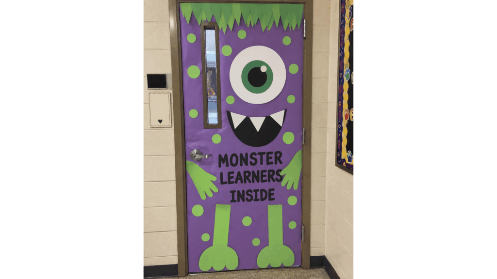 purple one-eyed monster classroom door reading "Monster Learners Inside"