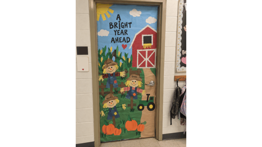 fall classroom door farm scene with paper scarecrows, a red barn, and a green tractor
