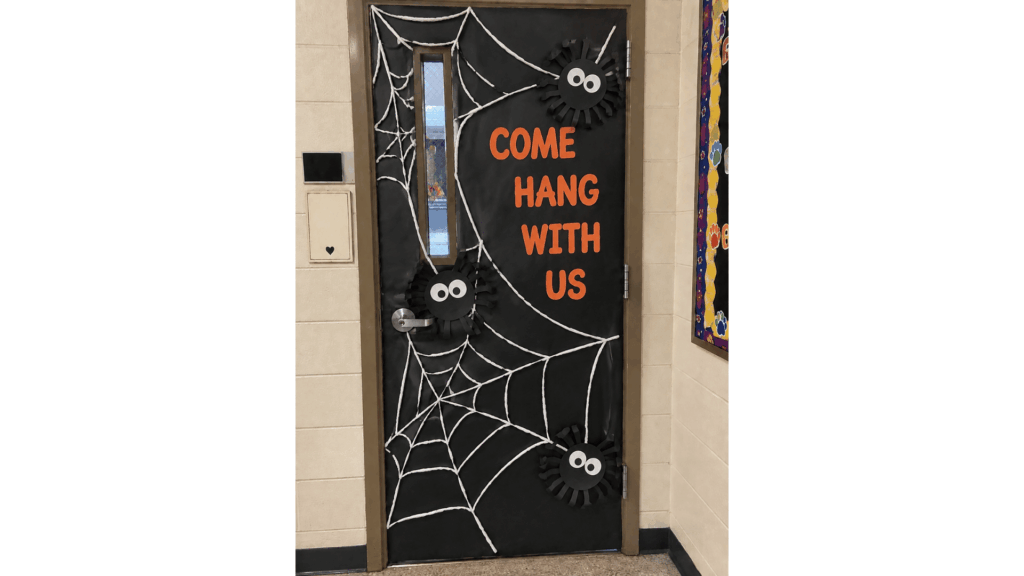 halloween classroom door with a spider web and the phrase "Come Hang With Us"