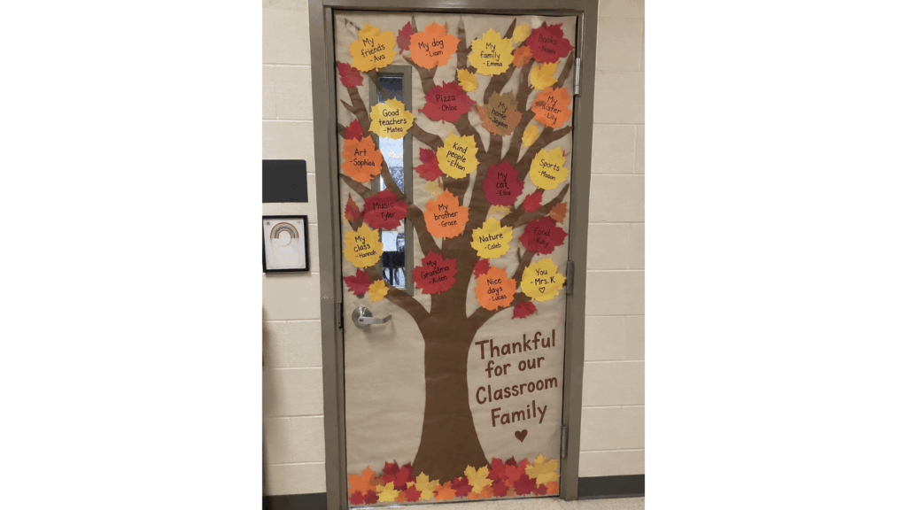 thankful tree classroom door with student gratitude notes written on paper leaves