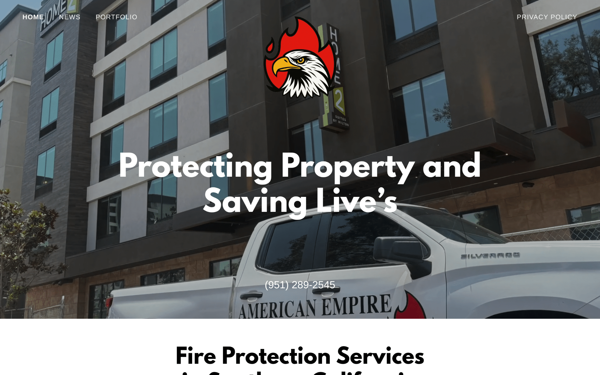 Fire protection company truck parked outside modern building with reflective windows